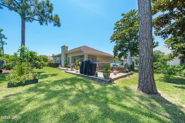 view of yard with a garden and a patio