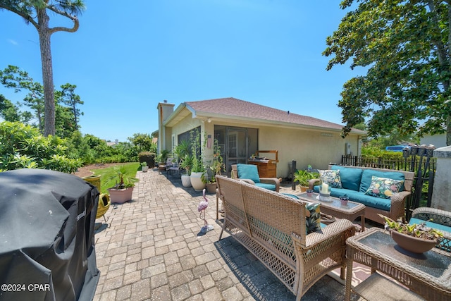 view of patio with area for grilling and an outdoor living space