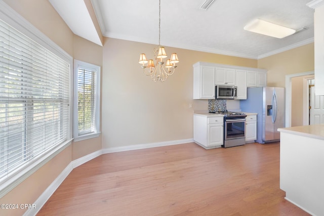 kitchen featuring white cabinets, hanging light fixtures, light hardwood / wood-style flooring, a notable chandelier, and stainless steel appliances