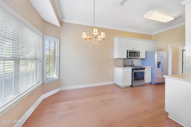kitchen featuring light countertops, light wood finished floors, visible vents, and appliances with stainless steel finishes