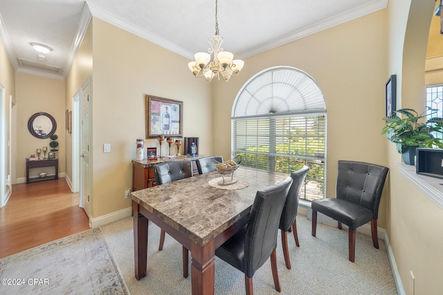 dining area featuring light carpet and crown molding