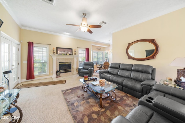 living room featuring ceiling fan, a fireplace, ornamental molding, carpet flooring, and visible vents