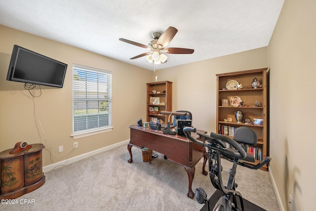 home office featuring a textured ceiling, light colored carpet, and ceiling fan