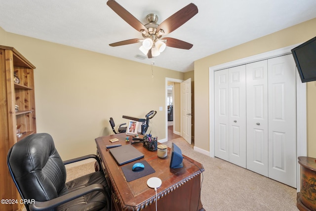 office area featuring baseboards, visible vents, light colored carpet, and ceiling fan