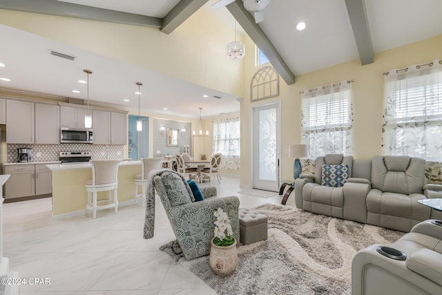 living room with beam ceiling, a chandelier, and high vaulted ceiling