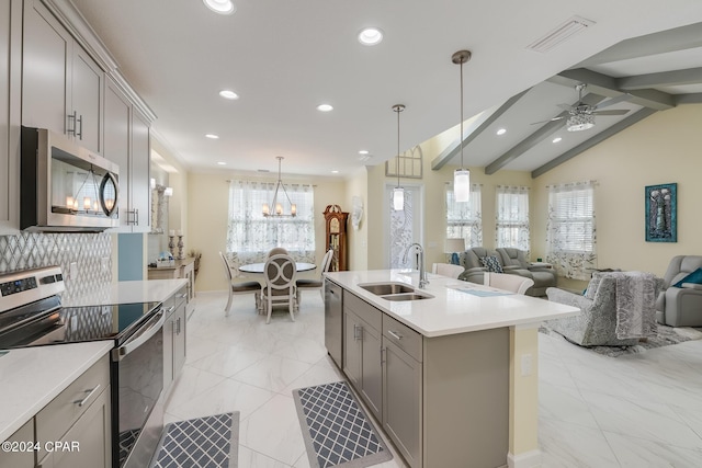 kitchen featuring appliances with stainless steel finishes, sink, pendant lighting, and gray cabinetry