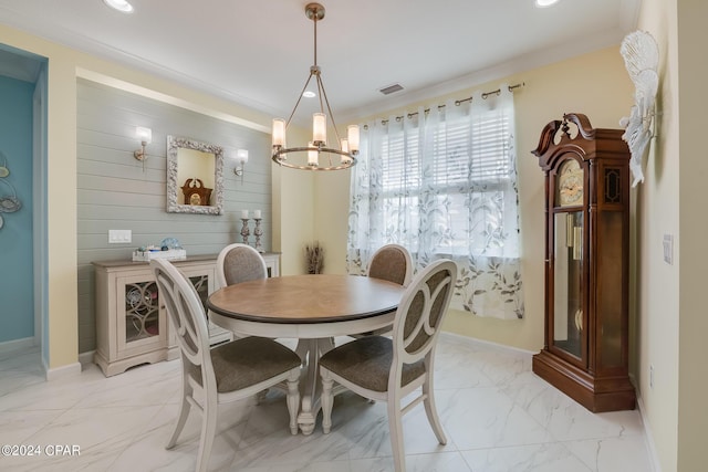 dining space featuring crown molding and a notable chandelier