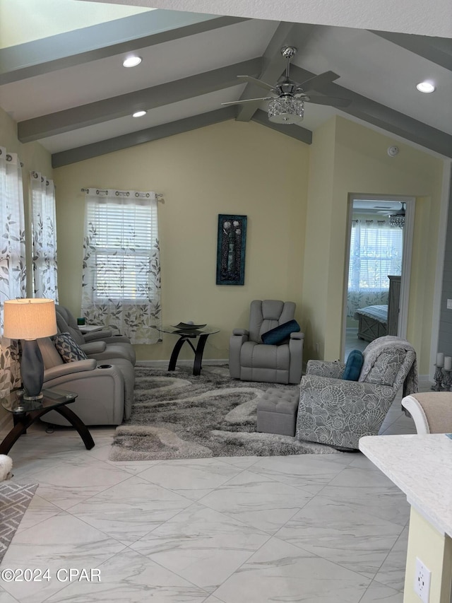 living room with ceiling fan, plenty of natural light, and lofted ceiling with beams