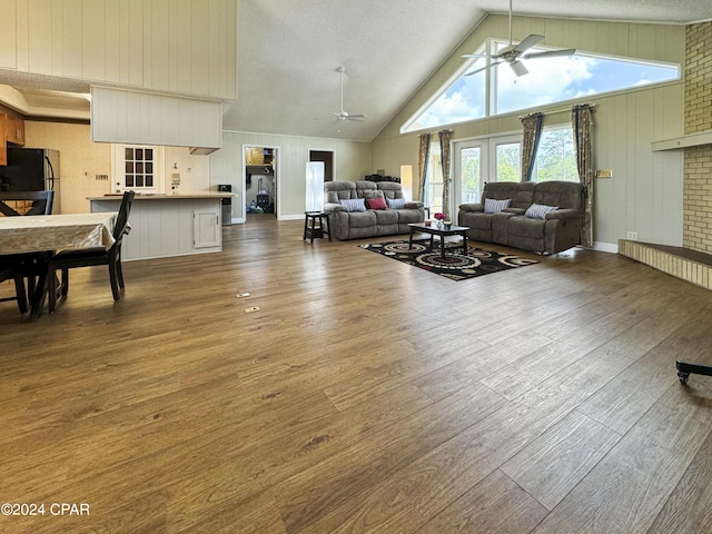 living room with ceiling fan, french doors, a textured ceiling, and hardwood / wood-style flooring