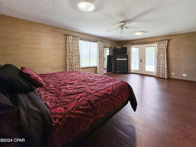 bedroom featuring ceiling fan, french doors, dark hardwood / wood-style floors, a textured ceiling, and access to outside