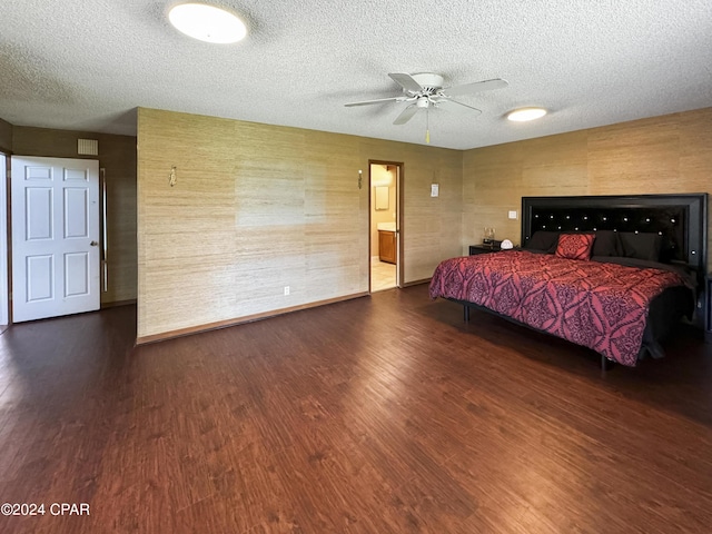 bedroom with dark hardwood / wood-style floors, ceiling fan, and a textured ceiling