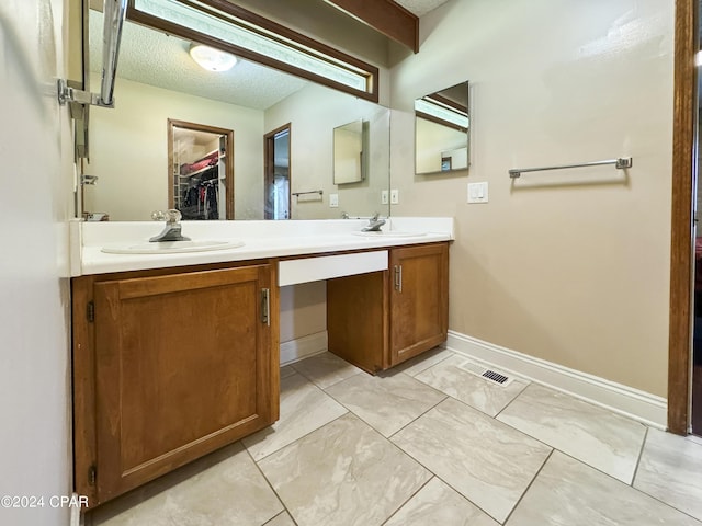 bathroom with vanity and a textured ceiling