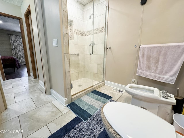 bathroom with a shower with door, toilet, and a bidet