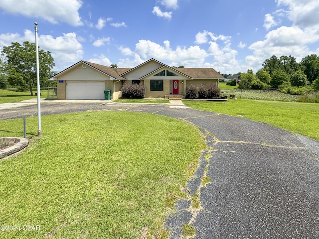 single story home with a garage and a front lawn