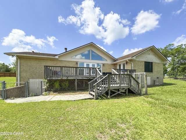 rear view of property featuring a yard and a wooden deck