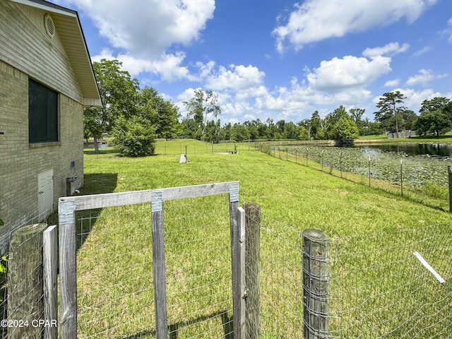 view of yard with a rural view and a water view