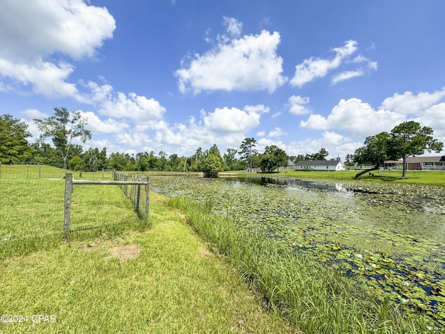 view of yard with a rural view and a water view