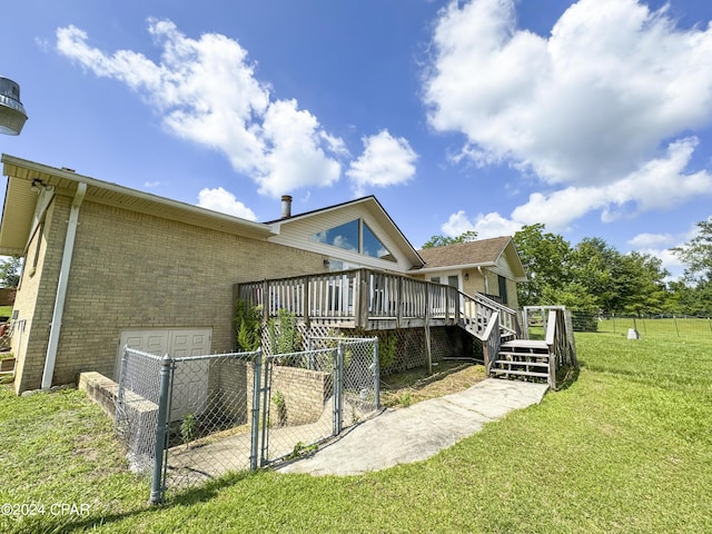 back of house with a wooden deck and a lawn