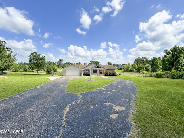 ranch-style house with a garage and a front lawn