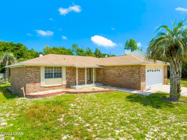 ranch-style home with a garage and a front lawn