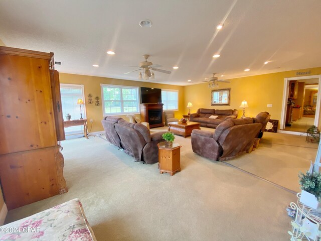 carpeted living room with ceiling fan