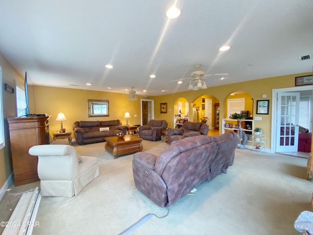 living room featuring carpet and ceiling fan