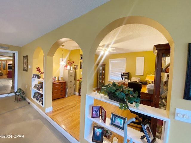 hallway featuring a textured ceiling and hardwood / wood-style floors