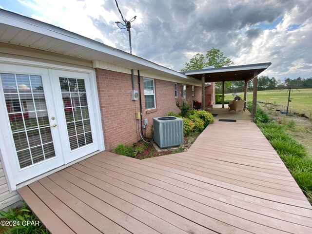 wooden deck featuring french doors and central air condition unit