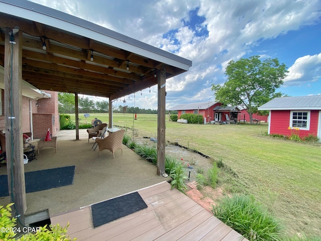 deck with a patio and a yard