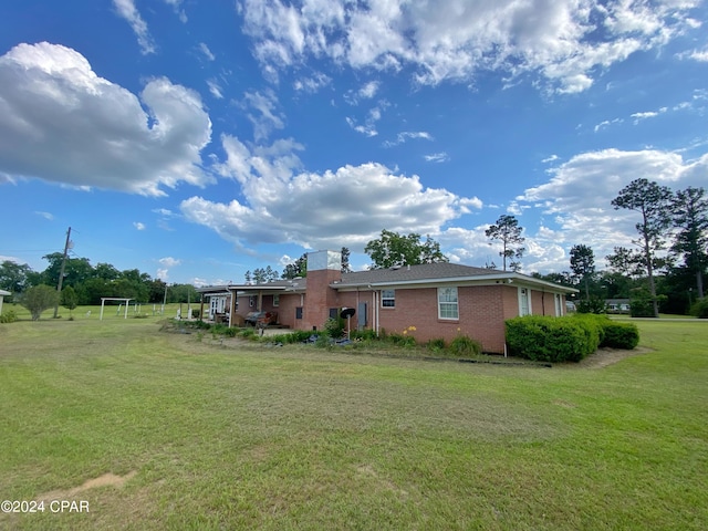 back of house with a yard