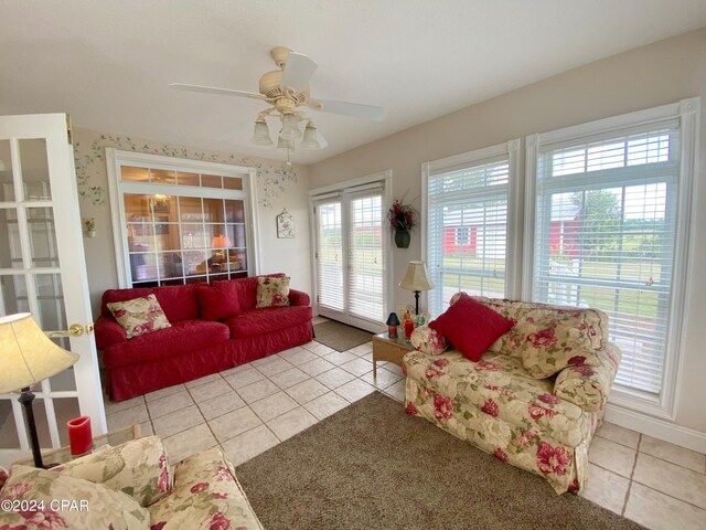 tiled living room with plenty of natural light and ceiling fan