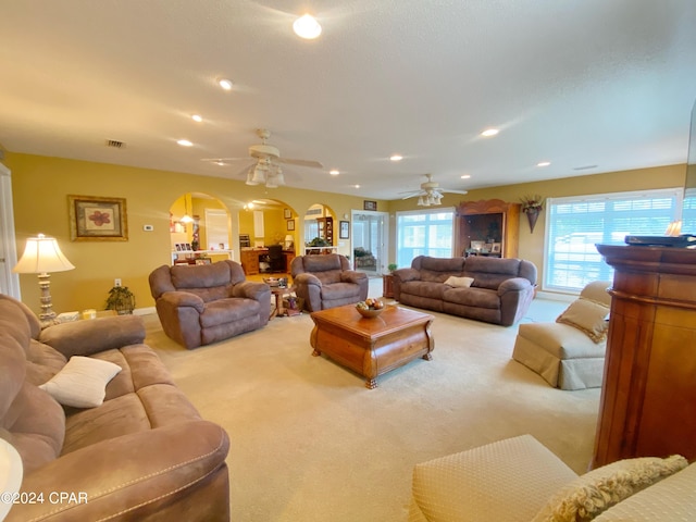 living room with ceiling fan and carpet floors