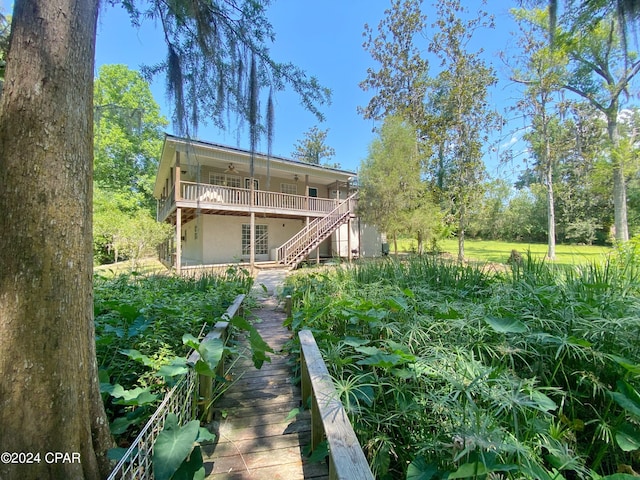 back of house featuring ceiling fan