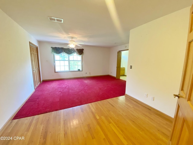 unfurnished room with ceiling fan and hardwood / wood-style floors