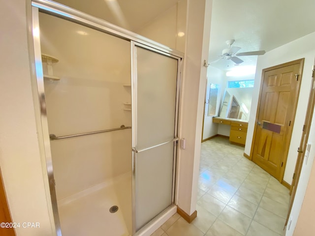 bathroom with ceiling fan and a shower with door