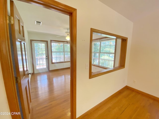 hallway with light hardwood / wood-style floors