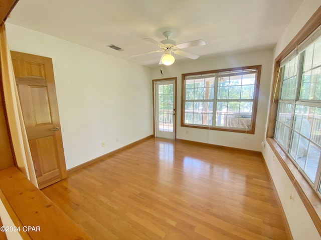 spare room featuring light hardwood / wood-style floors and ceiling fan