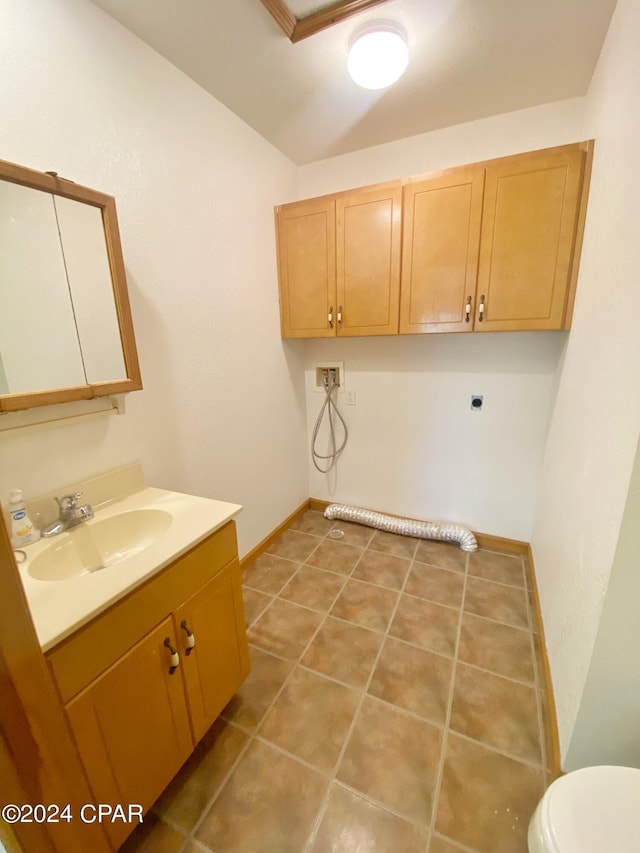 washroom with hookup for a washing machine, sink, and electric dryer hookup