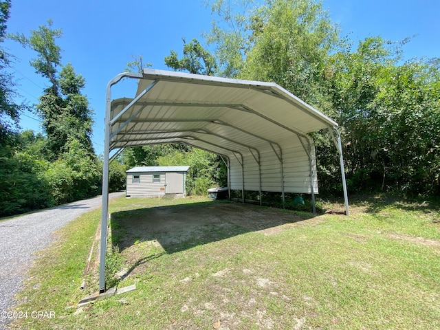 view of parking with a lawn and a carport