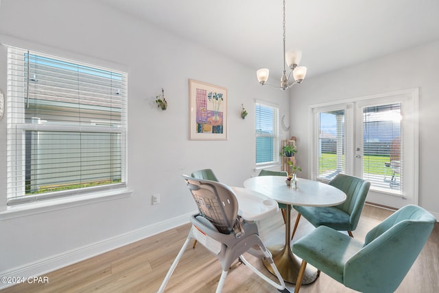 dining room featuring light hardwood / wood-style flooring and an inviting chandelier