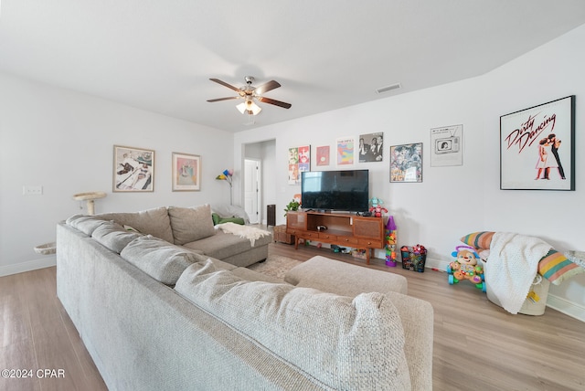 living room featuring hardwood / wood-style flooring and ceiling fan