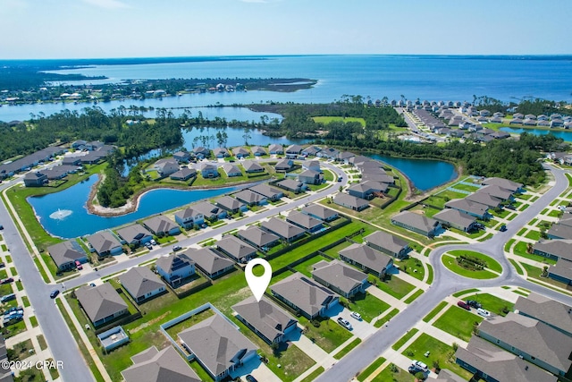 drone / aerial view featuring a residential view and a water view