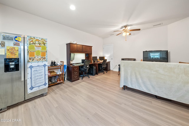 bedroom with light hardwood / wood-style floors, stainless steel refrigerator with ice dispenser, and ceiling fan