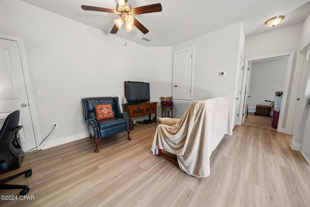 sitting room with light hardwood / wood-style floors and ceiling fan