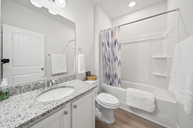 full bathroom featuring vanity, shower / tub combo, toilet, and hardwood / wood-style floors