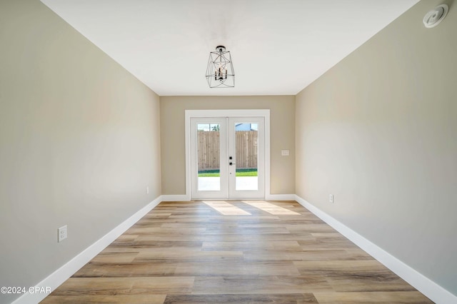 doorway to outside featuring light hardwood / wood-style floors and french doors