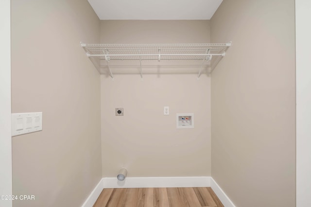 laundry room featuring washer hookup, wood-type flooring, and hookup for an electric dryer