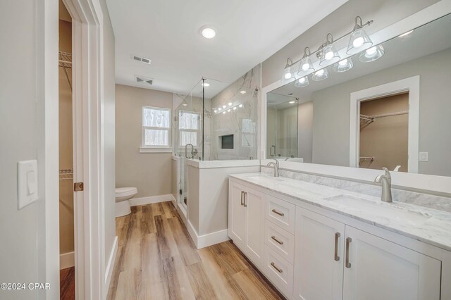 unfurnished bedroom featuring a tray ceiling, stainless steel refrigerator, ceiling fan, and light hardwood / wood-style floors