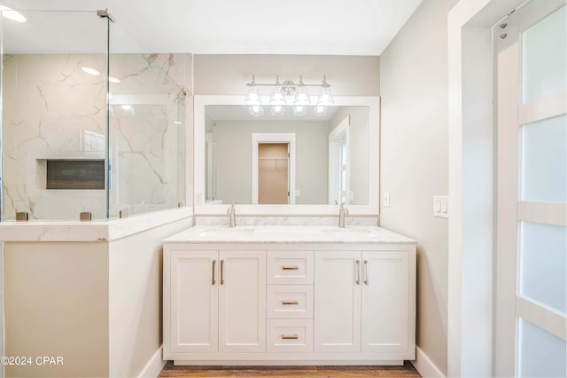 bathroom with toilet, vanity, a shower with shower door, and hardwood / wood-style flooring