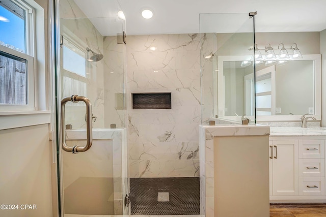 bathroom with vanity, hardwood / wood-style floors, and a shower with shower door